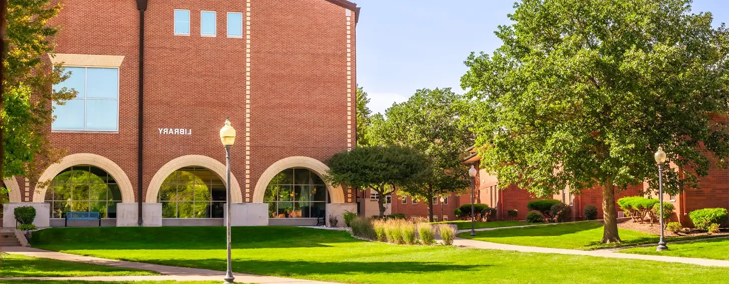 A photo of the SAU Library, a large brick building.